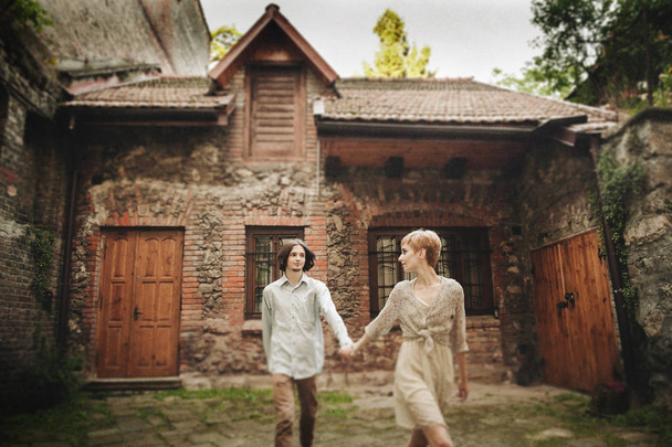 romantic couple against old house - Φωτογραφία, εικόνα