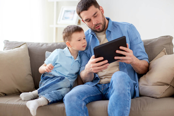 father and son with tablet pc playing at home - Valokuva, kuva