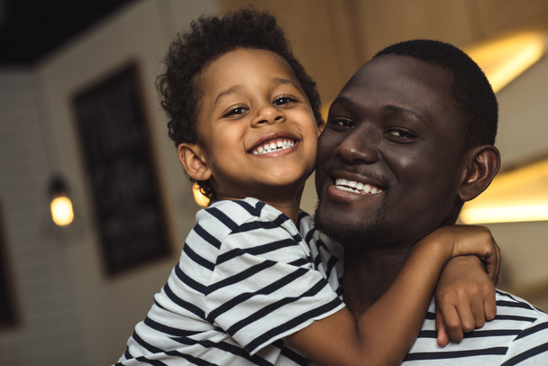 Африканский американский отец и ребенок обнимаются
 - Фото, изображение