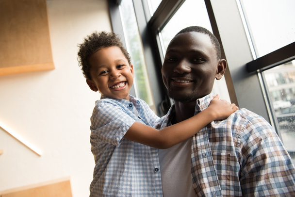 african american father and child hugging - 写真・画像