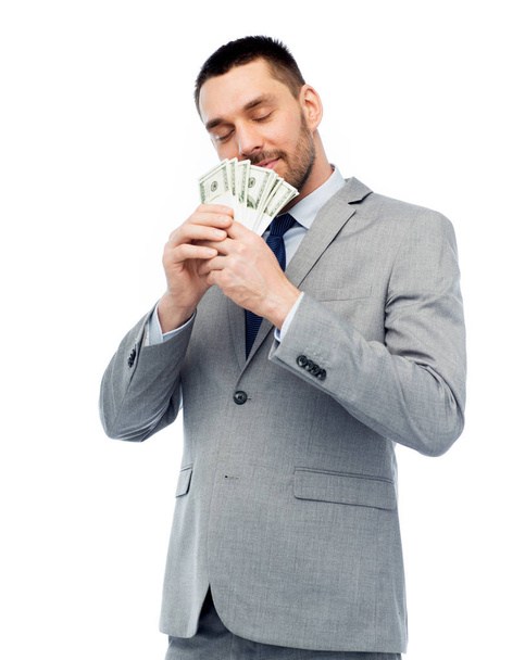 businessman smelling american dollar money - Foto, Imagen