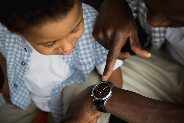 father and son checking wristwatch - Photo, Image