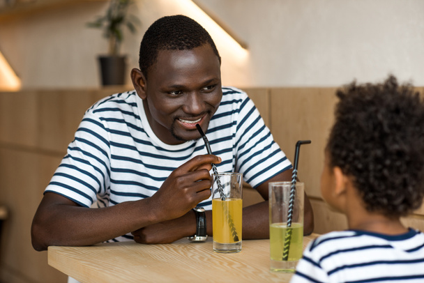 father and son drinking lemonade - Photo, image