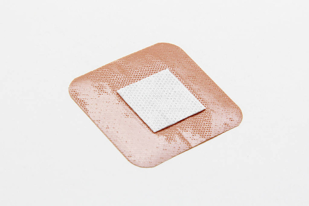 Medical adhesive plaster on white background - Foto, afbeelding