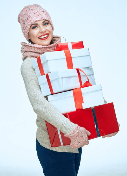 Smiling woman wearing warm clothes holds heap of gifts.  - Fotoğraf, Görsel