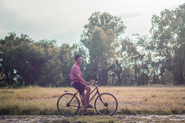 Asian men wear traditional dresses  with old bikes. - 写真・画像