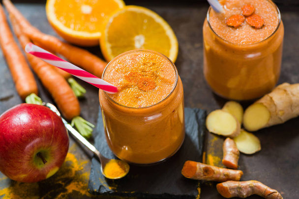 Smoothie with carrot, apple, orange, banana, ginger and tumeric - Photo, Image