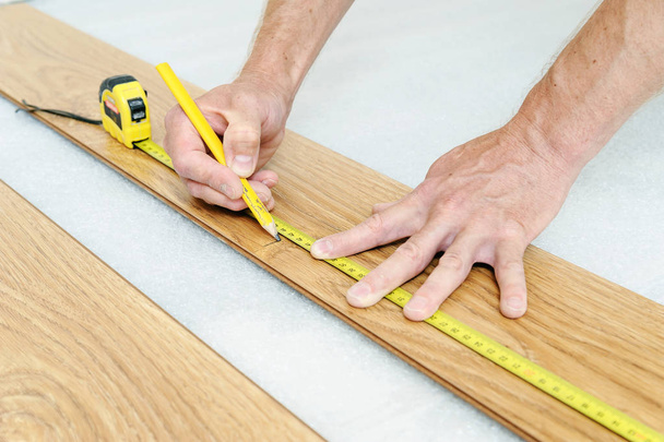 Installation of a laminate floorboard. - Photo, Image