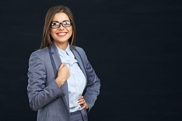 Smiling modern business woman portrait against black  - Fotó, kép