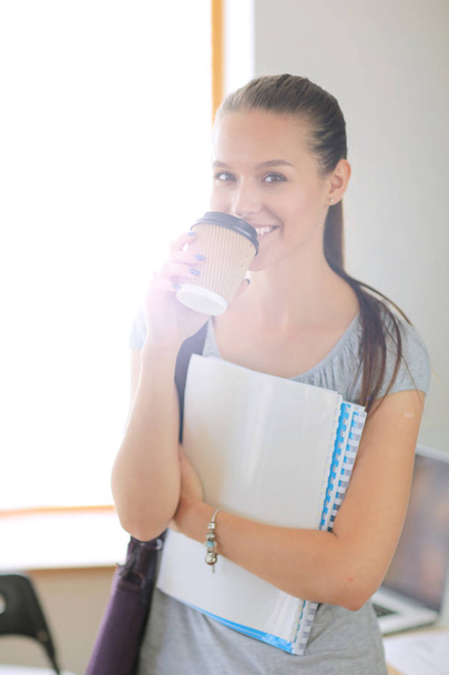 Portrait of young student woman holding exercise books. Student woman - Foto, Bild