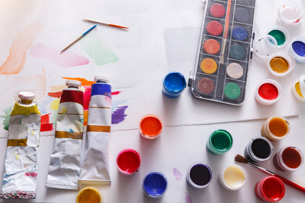 Artist workplace, set of color paints on wood desk - Foto, Bild