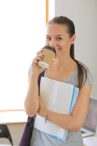 Portrait of young student woman holding exercise books. Student woman - Foto, imagen