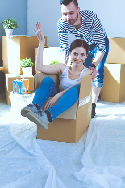 Happy young couple unpacking or packing boxes and moving into a new home. young couple - Valokuva, kuva