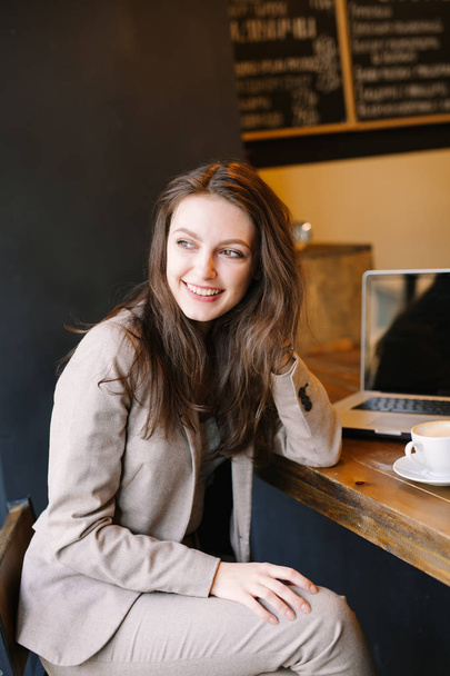 カフェに座って幸せ笑顔の若い女性. - 写真・画像