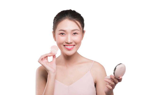 woman applying cosmetic blusher - Fotó, kép