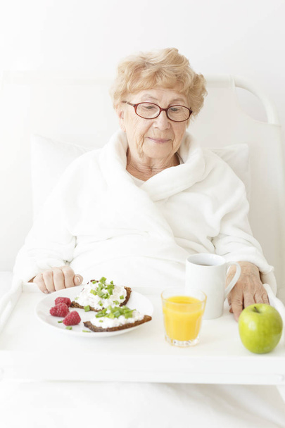 Grandmother in white dressing-gown - Foto, imagen