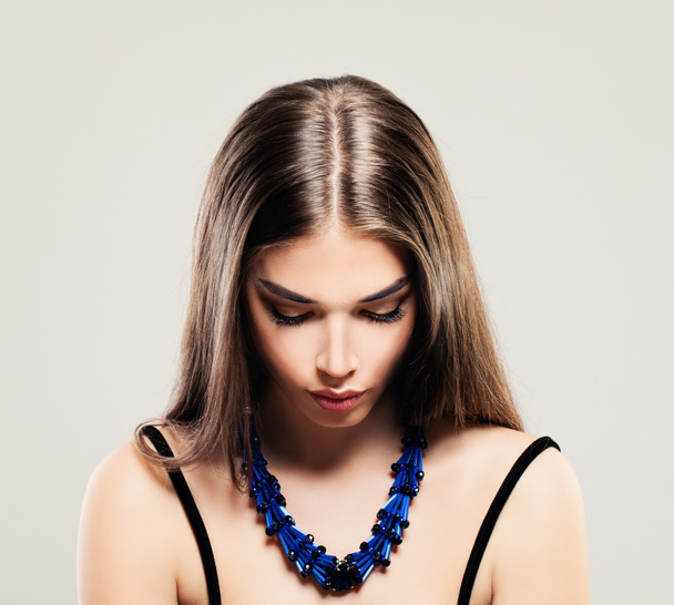 Beautiful Fashion Woman with Makeup and Blue Necklace - Фото, изображение