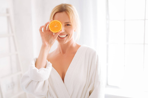 Happy woman posing with piece of orange - Foto, Imagem
