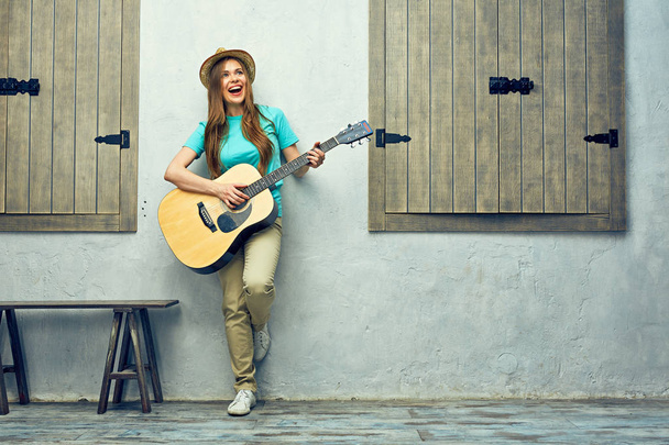 Positive woman playing guitar  - Foto, Imagen