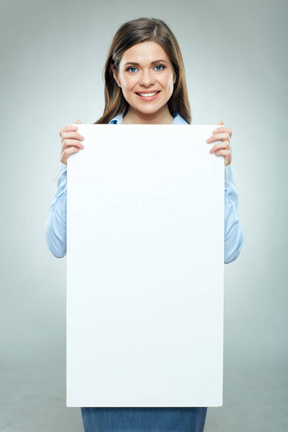 Happy young woman holding blank white  banner. - Valokuva, kuva