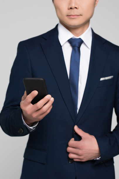 businessman looking at smartphone - Фото, изображение