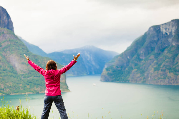 Woman with raised hands in norwegian mountains fjords - Foto, Imagem