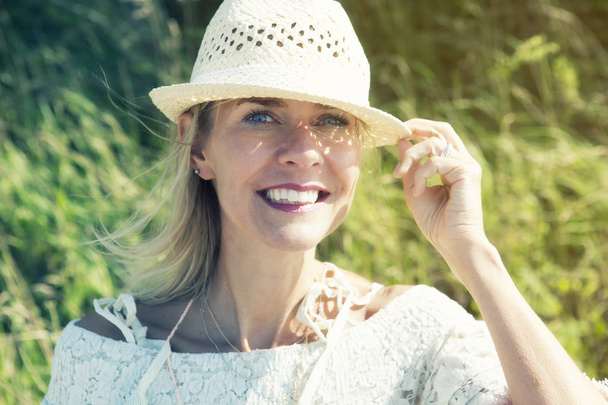 blond woman outdoors smiling at camera - Fotoğraf, Görsel