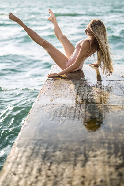 Ballerina posing on seafront - Valokuva, kuva