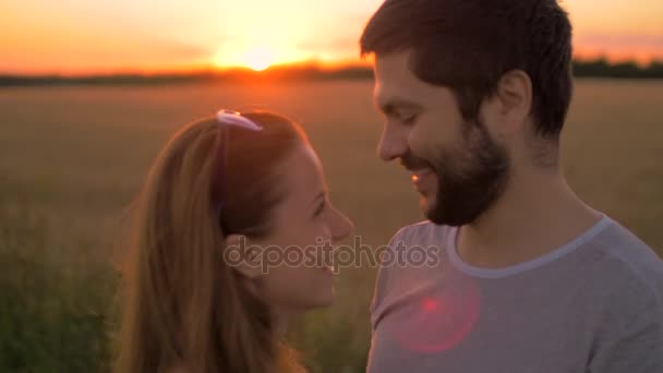 Bájos fiatal pár csókolózás Búzamező naplementekor - Felvétel, videó