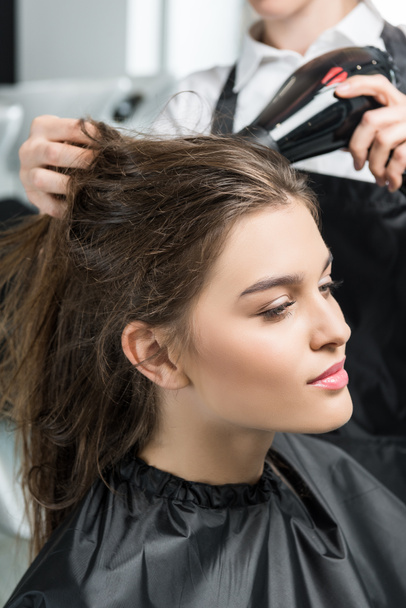 hairdresser drying hair of woman - Photo, Image
