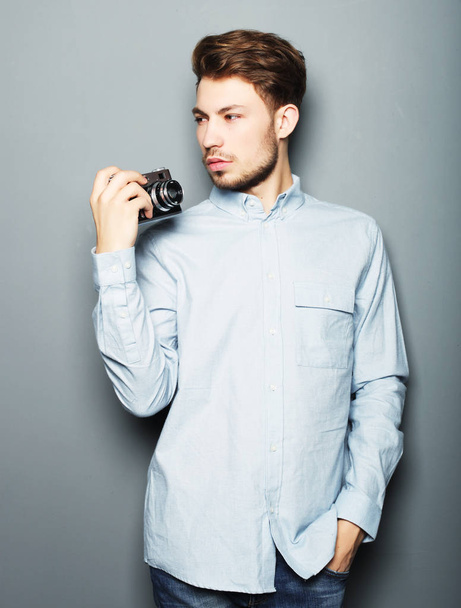 Hipster fashion photographer man holding retro camera - Фото, зображення