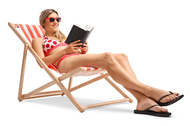 woman reading a book in a deck chair - Fotó, kép