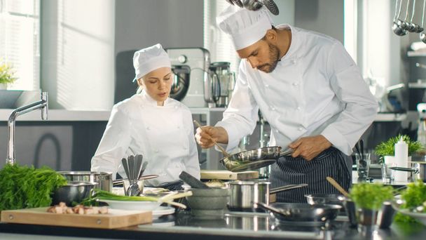 Famous Chef and His Female Apprentice Prepare Special Dish in a  - Foto, afbeelding