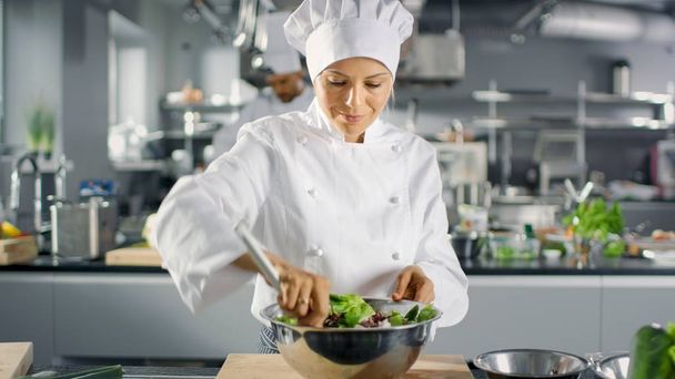 In a Famous Restaurant Female Cook Prepares Salad. She Works in  - 写真・画像