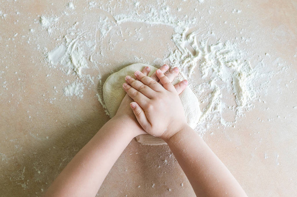 Childrens hands make dough - Photo, Image