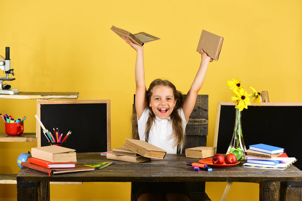 Childhood and back to school concept. Girl sits at desk - Foto, Imagen