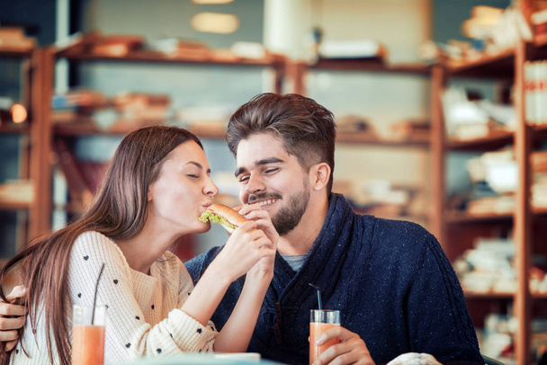 Couple eating sandwich - Photo, Image