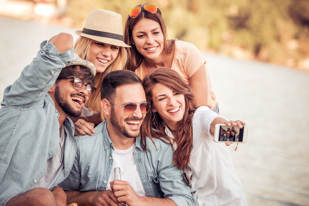 Group of friends taking selfie on the beach - Photo, Image