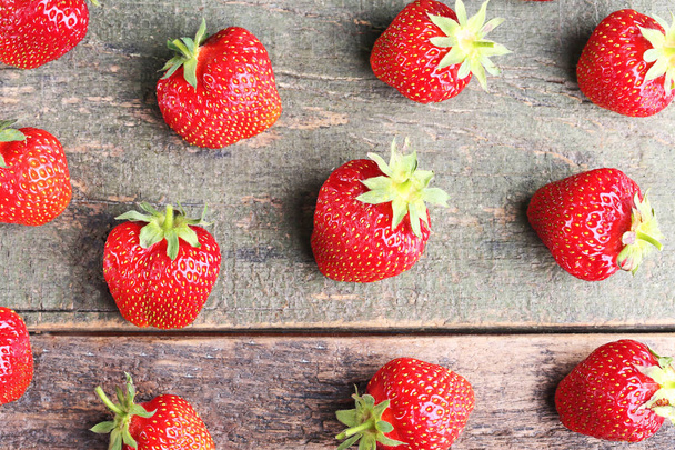 Fresh strawberries on grey wooden table - Foto, afbeelding