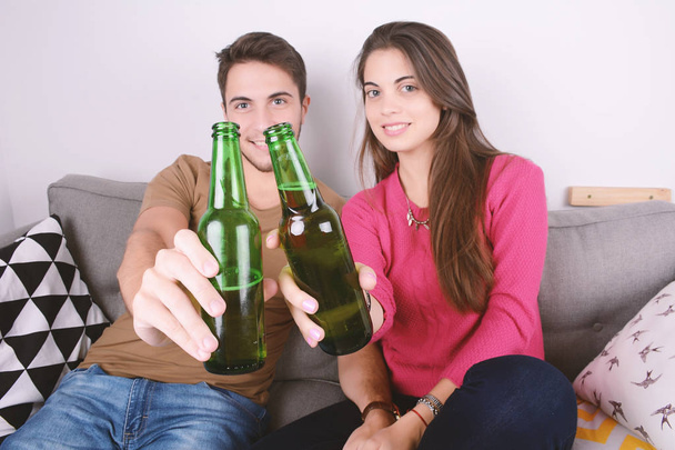 Couple drinking beer on couch. - Photo, Image