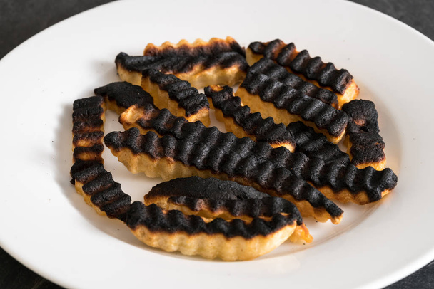 Plate of ruined and burned french fries - Photo, Image