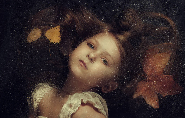 Little caucasian girl, close up portrait across a water drops - Photo, Image