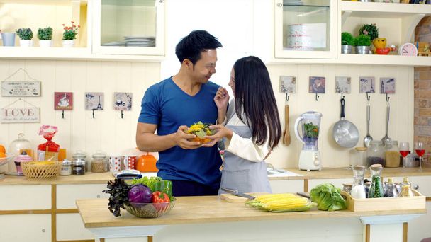 Young Asian wife is preparing clean food for husband - Photo, image