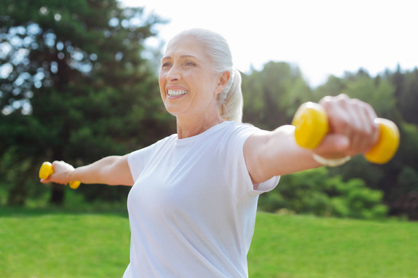 Attractive elderly woman demonstrating her strength - Photo, Image