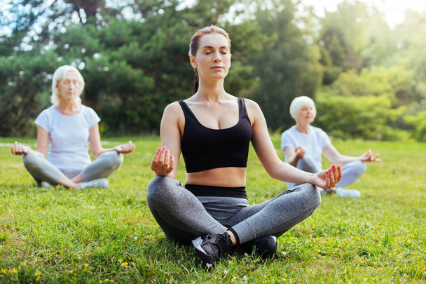 Enigmatical yoga tutor relaxing on fresh air - Foto, imagen