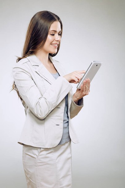 Business woman suit wearinf using tablet for work. - Fotó, kép