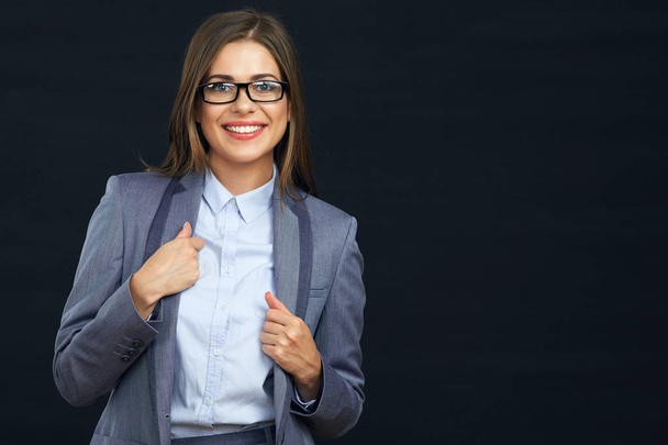 Portrait of smiling business woman on black studio background - Foto, immagini