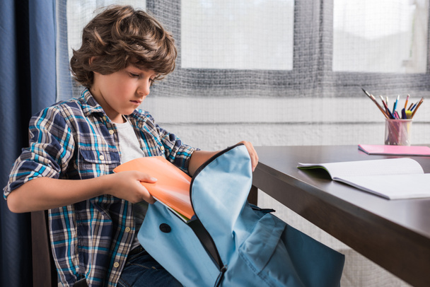 child packing backpack for school - Photo, Image