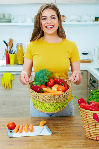woman holding wicker basket with vegetables  - Valokuva, kuva