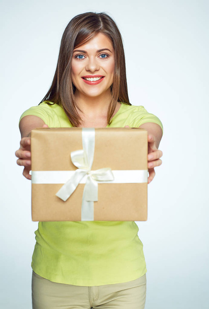 Smiling woman holding gift box  - Фото, изображение